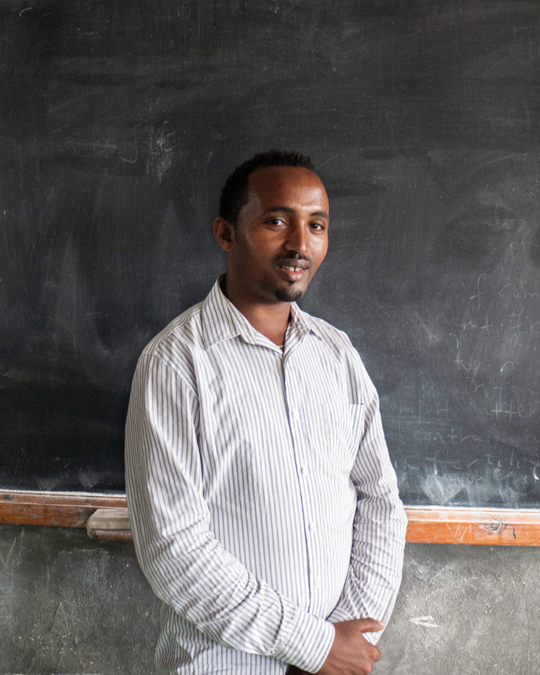 Hailu posing for a photography at the green flower foundation class room