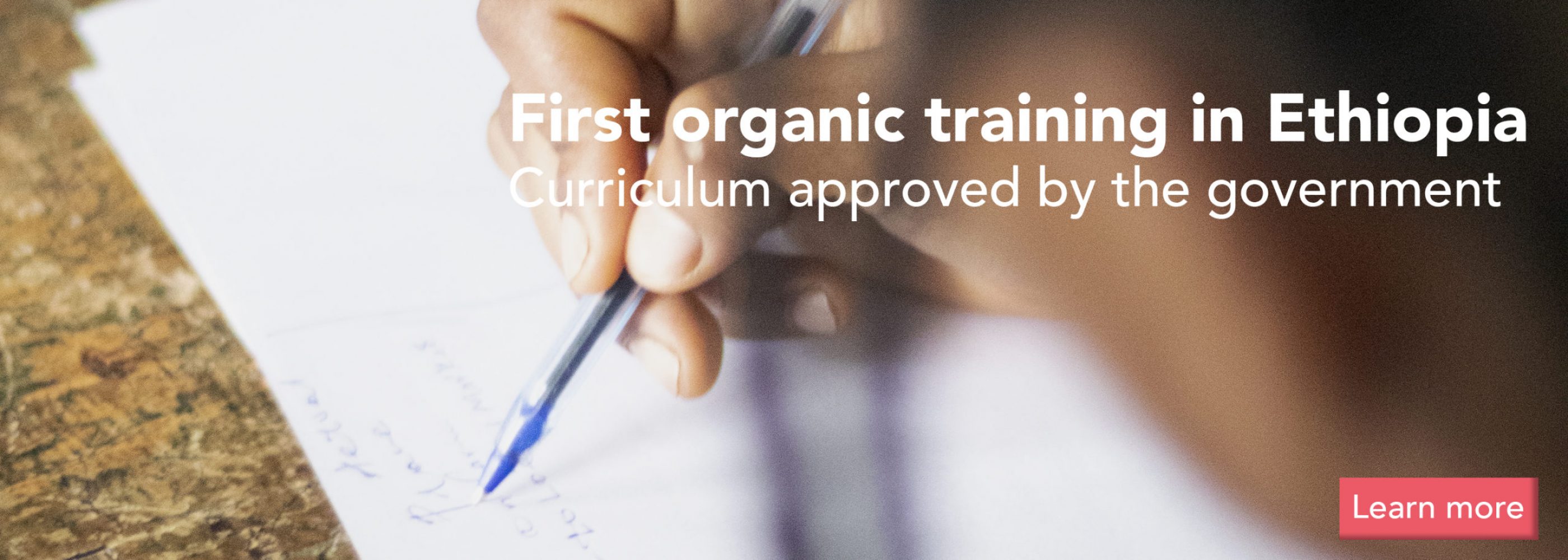Student's hand writing her organic-farming lesson